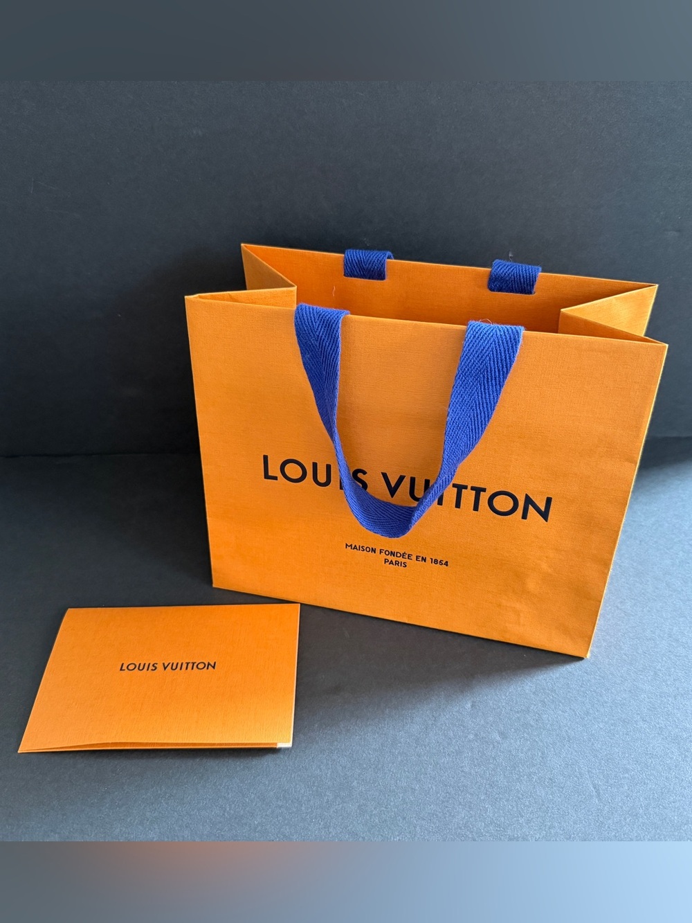 Louis Vuitton Orange Shopping Bag with Blue Handles and Receipt Card